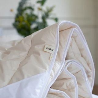 A close up of the Floks Luxury British Winter Wool duvet showing a branded label