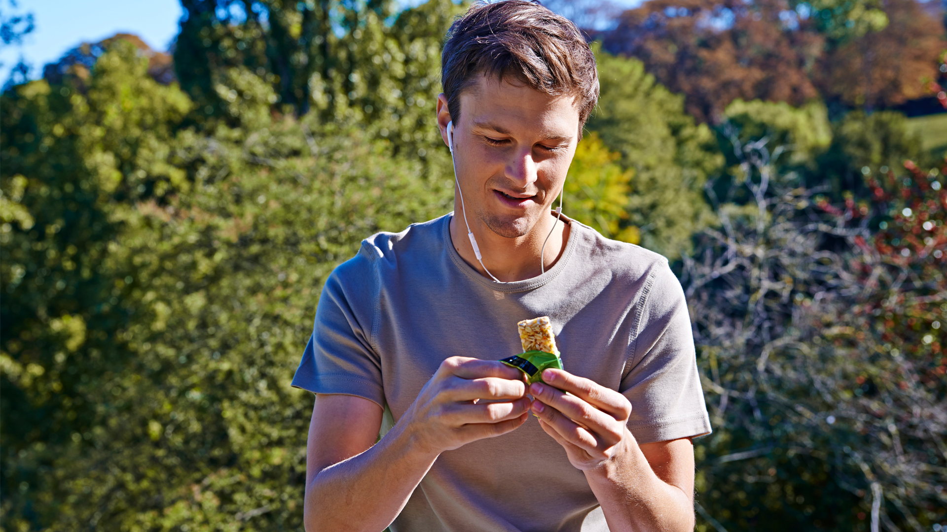 man sat eating one of the best protein bars