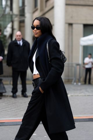 A picture of Laura Harrier wearing a studded bag.