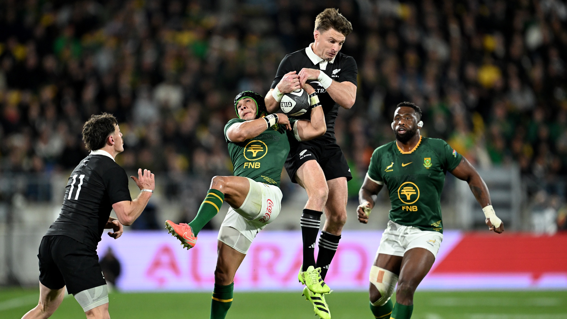 Cheslin Kolbe of South Africa and Beauden Barrett of New Zealand compete for the ball during a rugby union match between New Zealand All Blacks and South Africa Springboks.