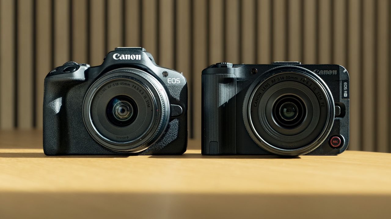 Canon EOS R50 V on a wooden table, alongside the EOS R50