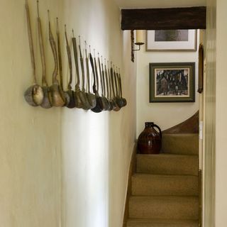 staircase with wooden spoon on side wall