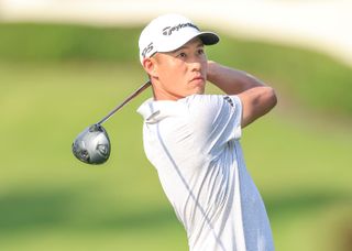 Collin Morikawa watches his tee shot