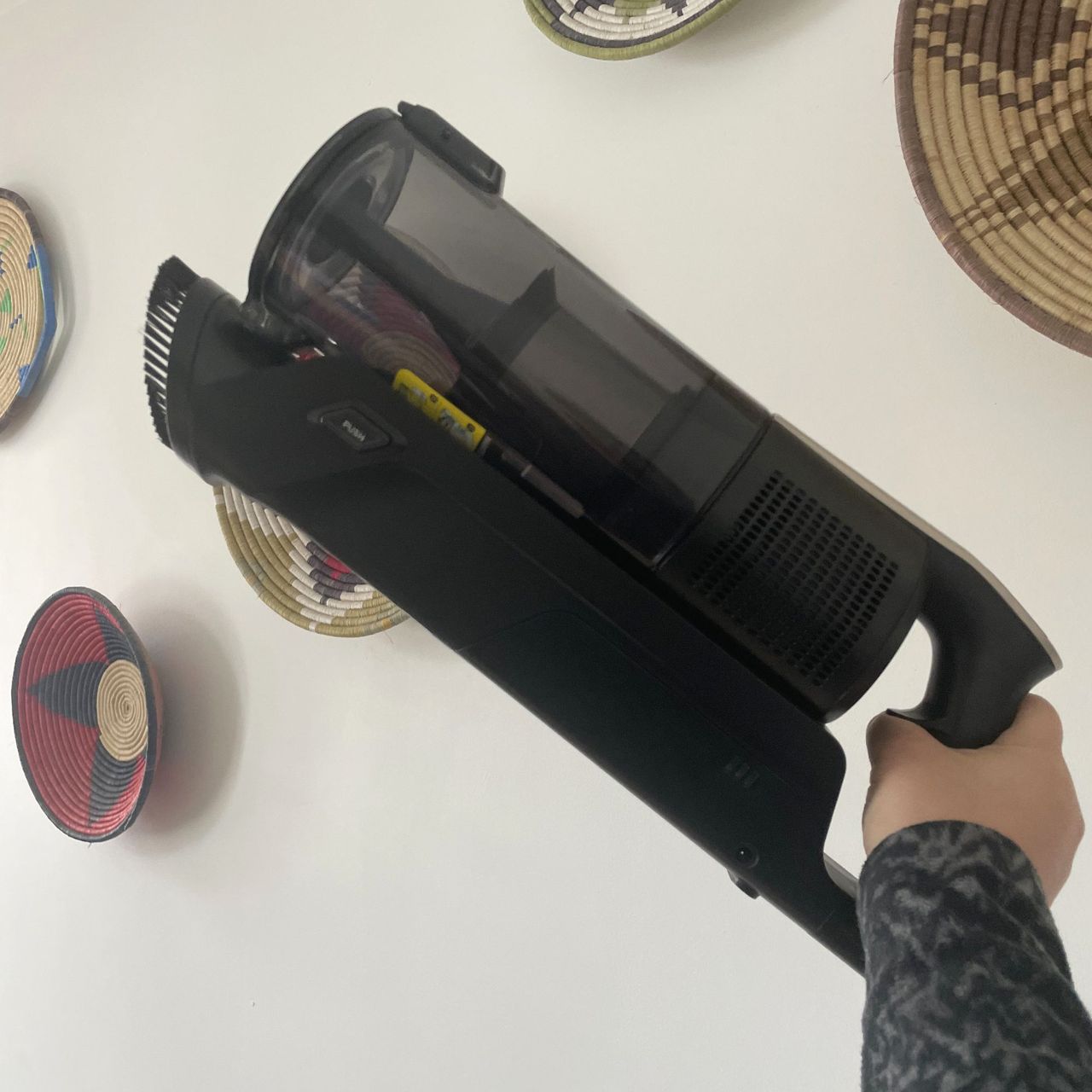 Hand holding up the handheld unit of the Hoover HF3 Pet DynamicClean Cordless Vacuum