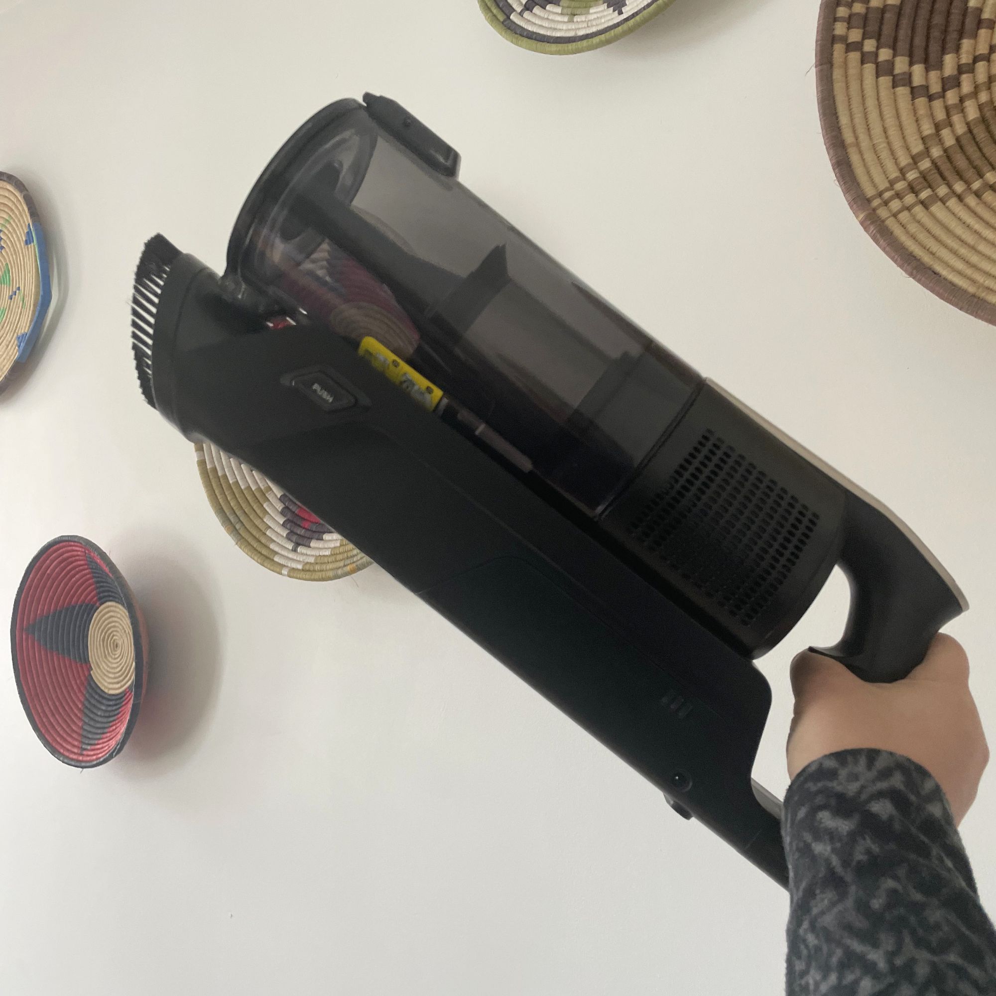 Hand holding up the handheld unit of the Hoover HF3 Pet DynamicClean Cordless Vacuum