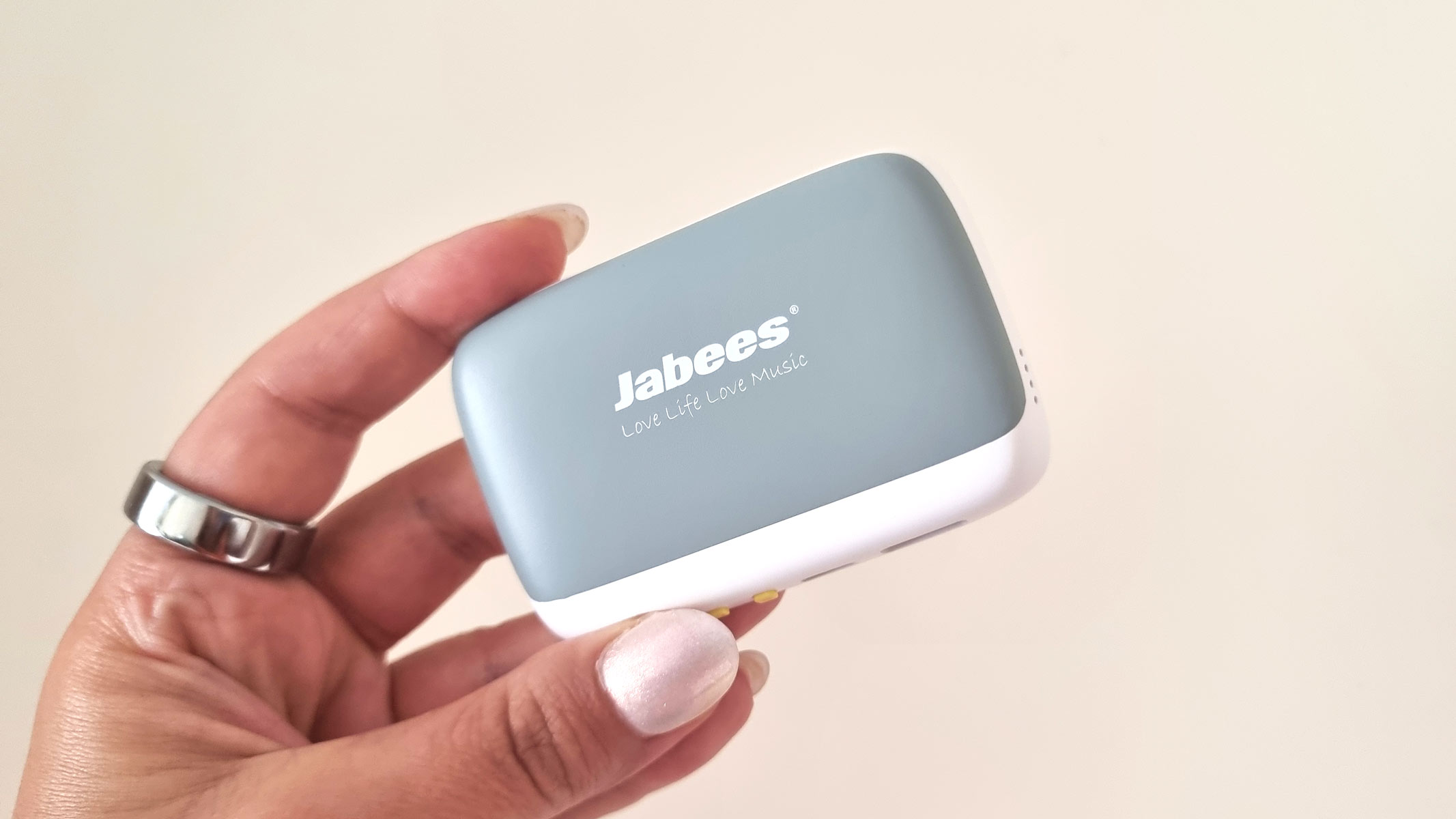 a close-up picture of our reviewer holding the Jabees Peace Pillow Speaker