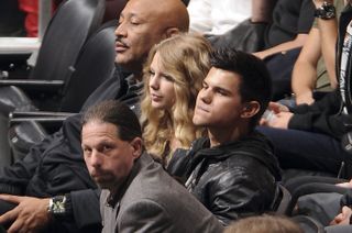 Taylor Swift and Taylor Lautner at a hockey game