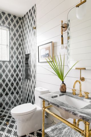 A bathroom with shiplap walls and wall tiles