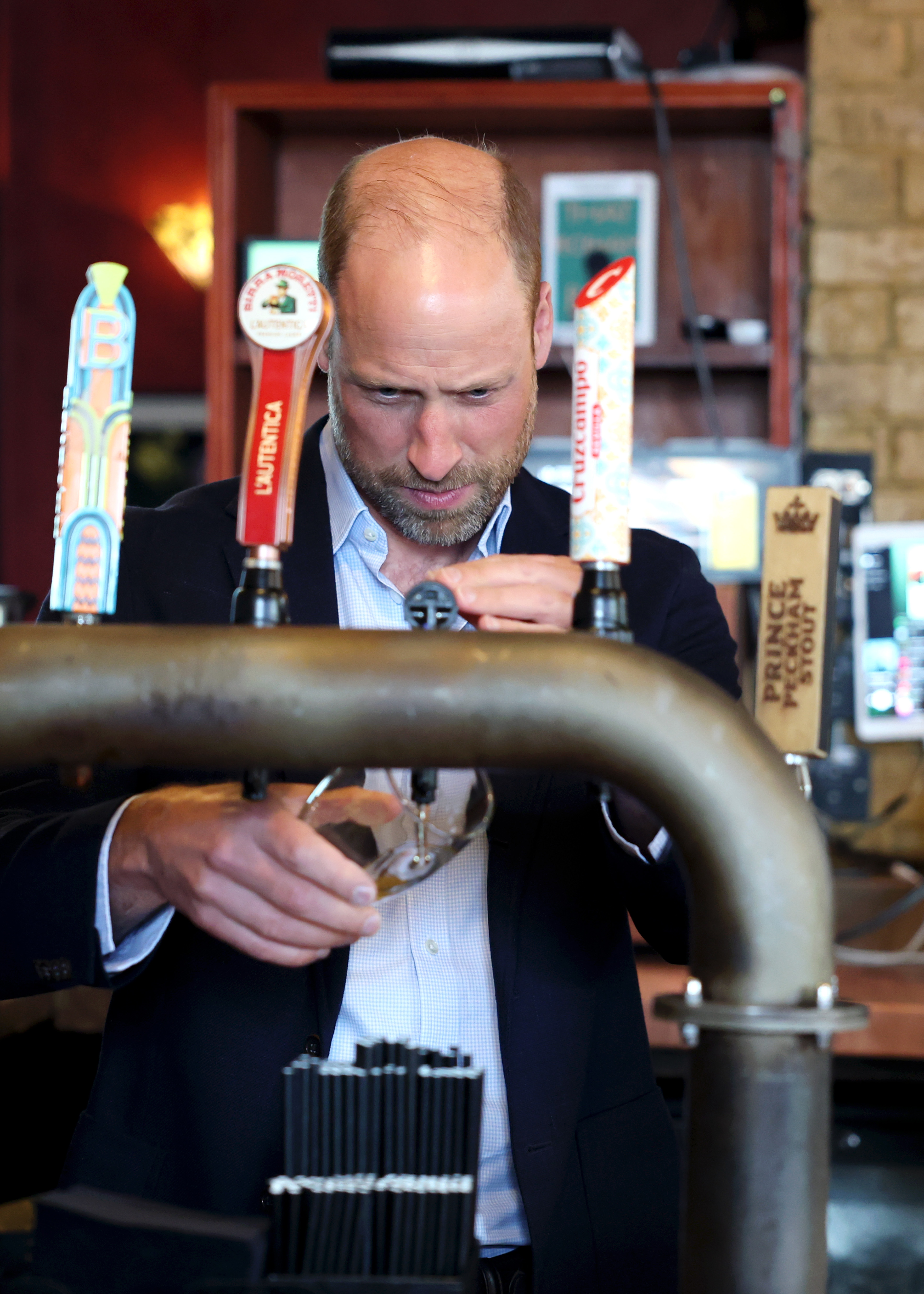 LONDON, ENGLAND - JUNE 03: Prince William, Prince of Wales pours a pint during his visit to The Prince of Peckham pub in Peckham on June 03, 2026 in London, England. The Prince of Wales visited grassroots initiatives encouraging positive social change. (Photo by Chris Jackson/Getty Images)