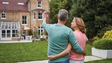 Equity release symbolised by a middle-aged couple appraising their home