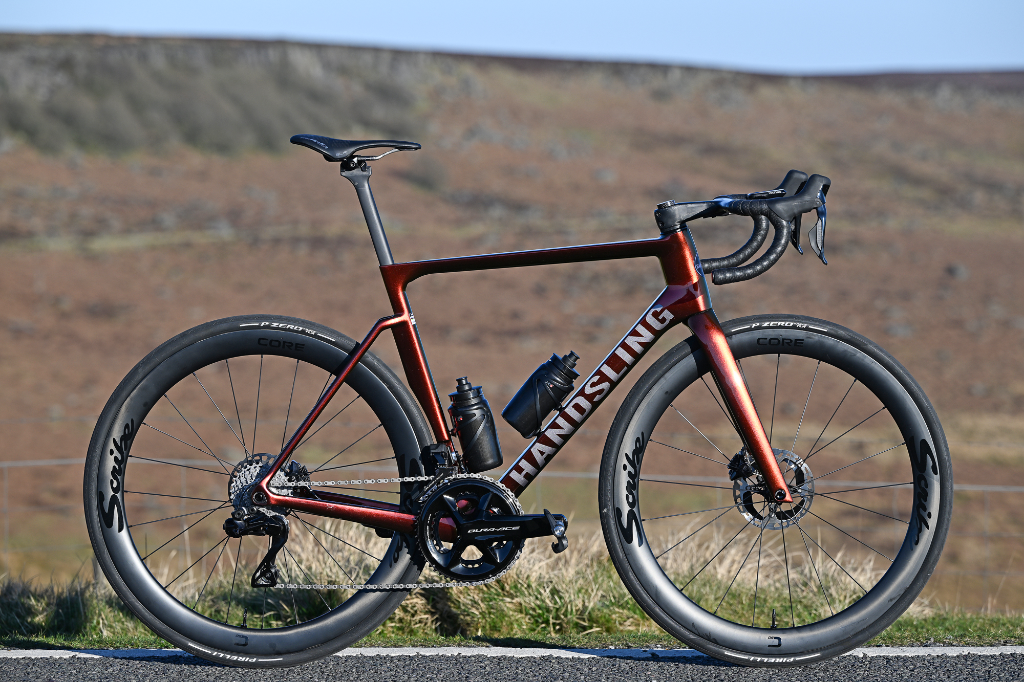 Sunset Gold Handsling A1R0evoS road bike on its own on a moorland road
