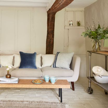 panelled living room with beige sofa