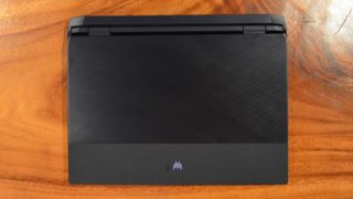 An Acer Predator Helios 300 (2022) sitting on a wooden table in a commissary
