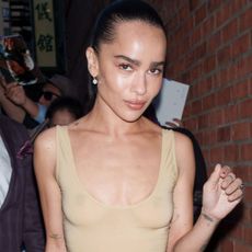 Zoe Kravitz at a screening for Blink Twice wearing a sheer Yves Saint Laurent nude bodysuit and black plisse skirt.