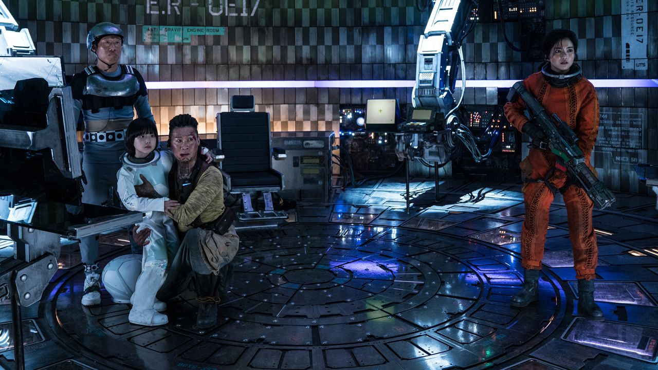 Tiger Park (Seon-kyu Jin) and Captain Jang (Kim Tae-ri) help Kot-nim find her father, Kang Hyun-Woo (Mu-Yeol Kim) in "Space Sweepers" on Netflix.