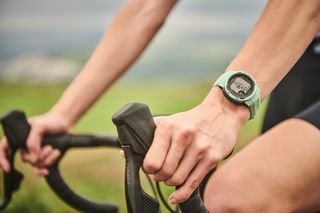 Female cyclist wearing a Garmin smartwatch