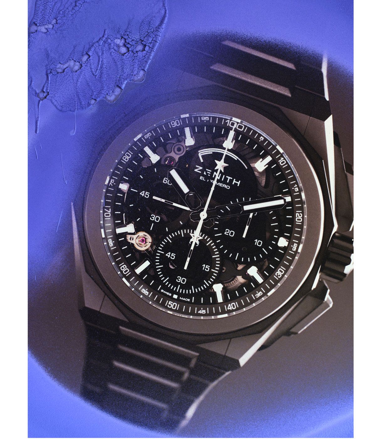 Zenith black watch against a blue background