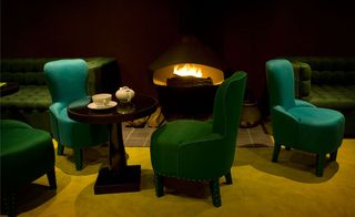 Green chairs next to fire