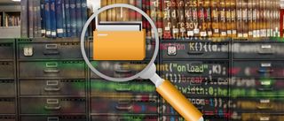 A magnifying glass used to find a large folder