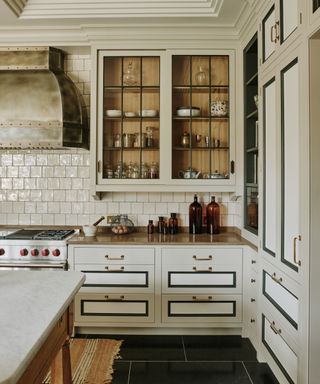 Glazed cabinet with natural wood interior by Artichoke