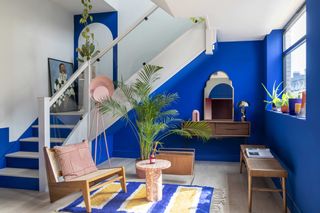 a entryway painted in bright cobalt blue