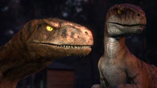 Two Atrociraptors stand together in the dark woods in Jurassic World: Chaos Theory.