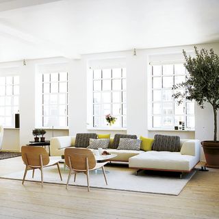 living room with white wall and wooden flooring with chair