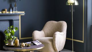 Best living room paint colors include black walls, pictured here with a gold border