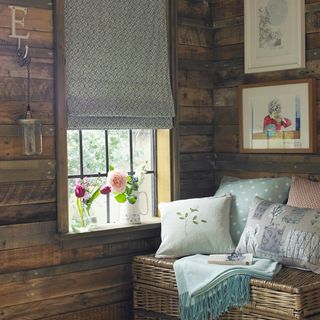 wooden shed with cushions and flower vase