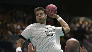 Renars Uscins (C) attempts to score past Sweden's pivot #32 Oscar Bergendahl on the way to the Germany vs Spain men's handball semi-final at Olympics 2024