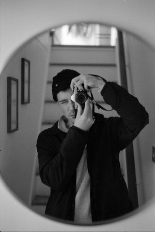 Selfie in a mirror taken on Ilford HP5 Plus 35mm film
