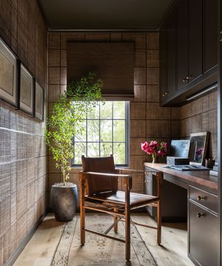 cozy panelled home office with a chocolate brown ceiling and wooden furniture