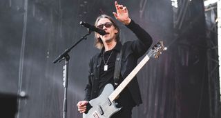 Myles Kennedy makes his point during an early evening festival performance. He plays his signature PRS T-style and wears all black.