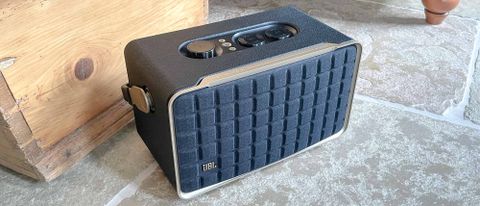 JBL Authentics 300 speaker on floor near a wooden crate