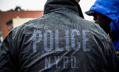 New York Police Department officers monitor a march against stop-and-frisk tactics used by police on February 23.