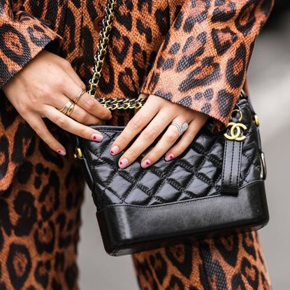 Valentine's Day nails - heart manicure holding Chanel bag