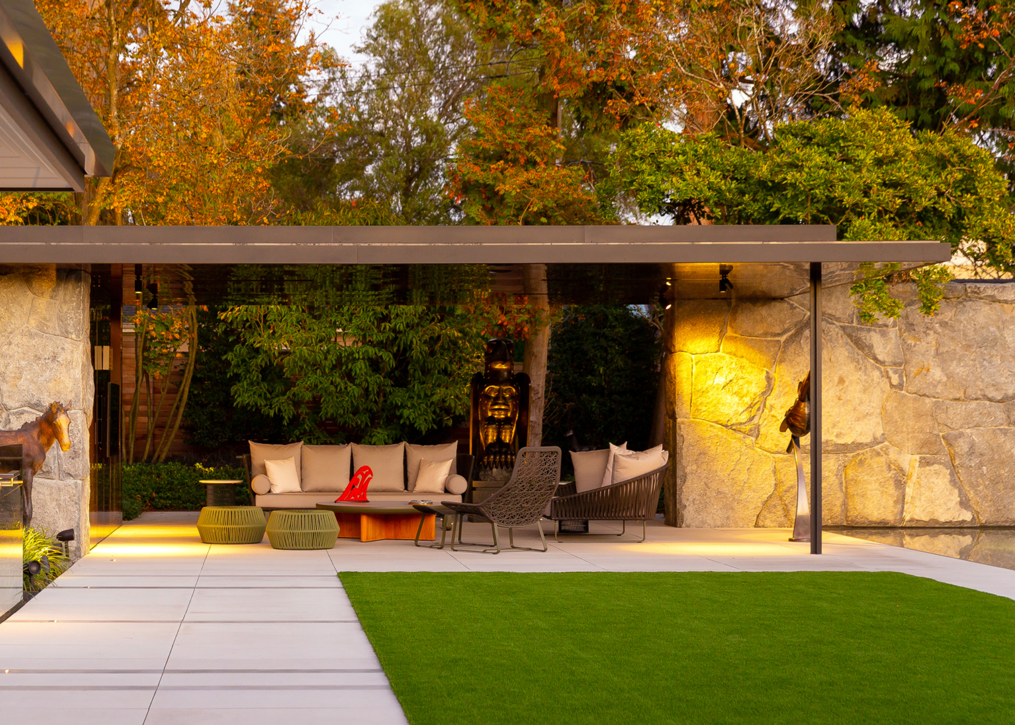 A patio with furniture including a large sofa and patio chairs