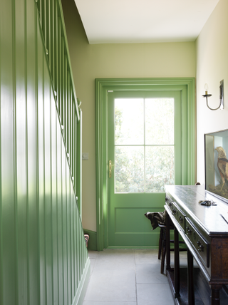 A hallway painted in a bright green tone