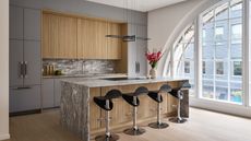 A modern kitchen with a marble waterfall island and sleek greige cabinetry