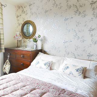 bedroom with wallpaper and mirror