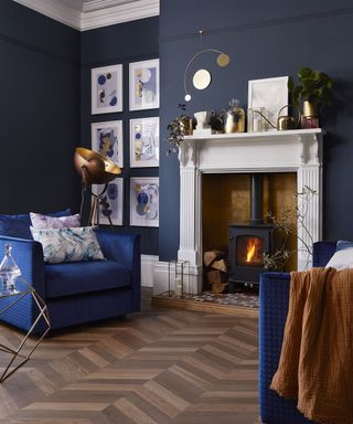 Fireplace with dark blue wall decor and LVT flooring