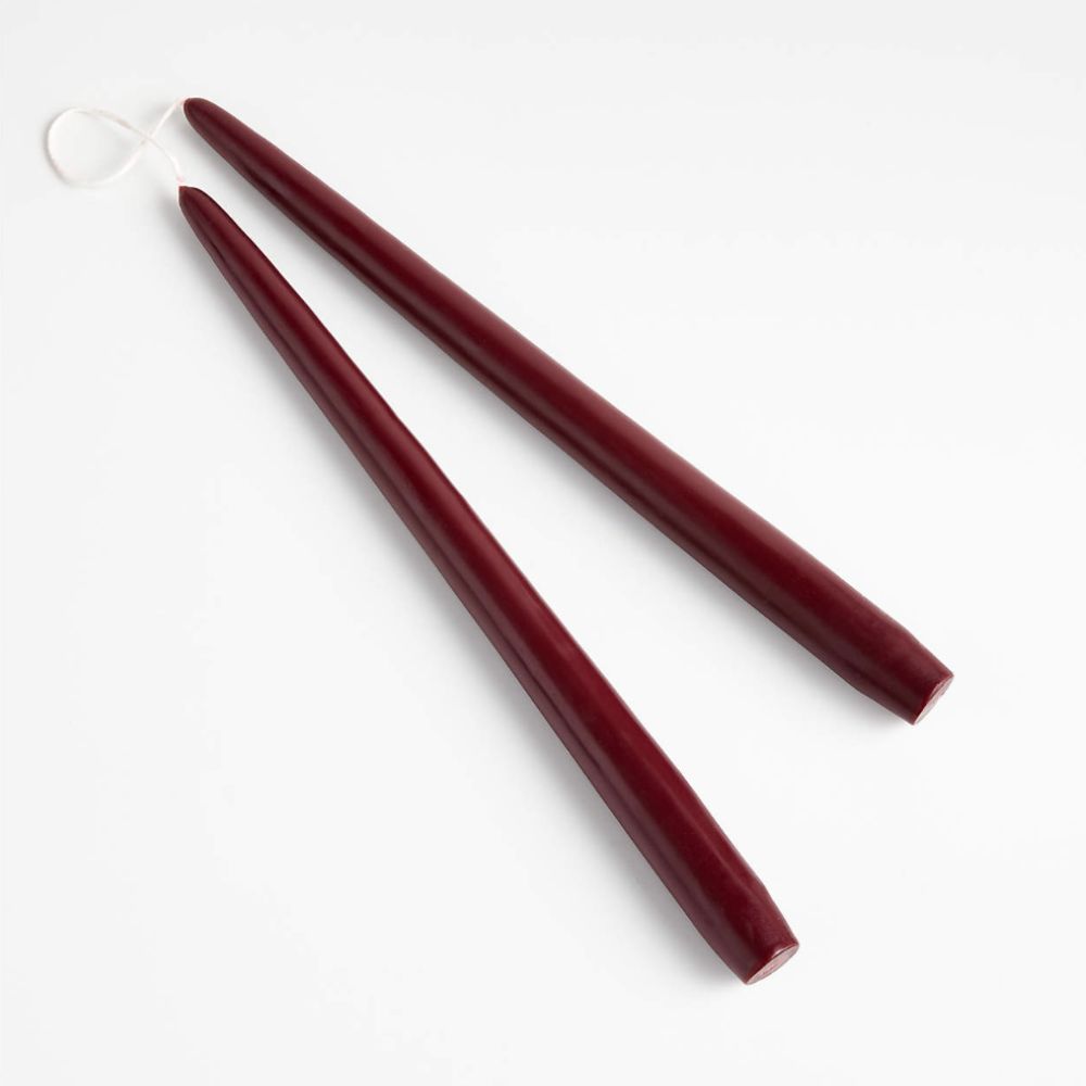 two dark red taper candles