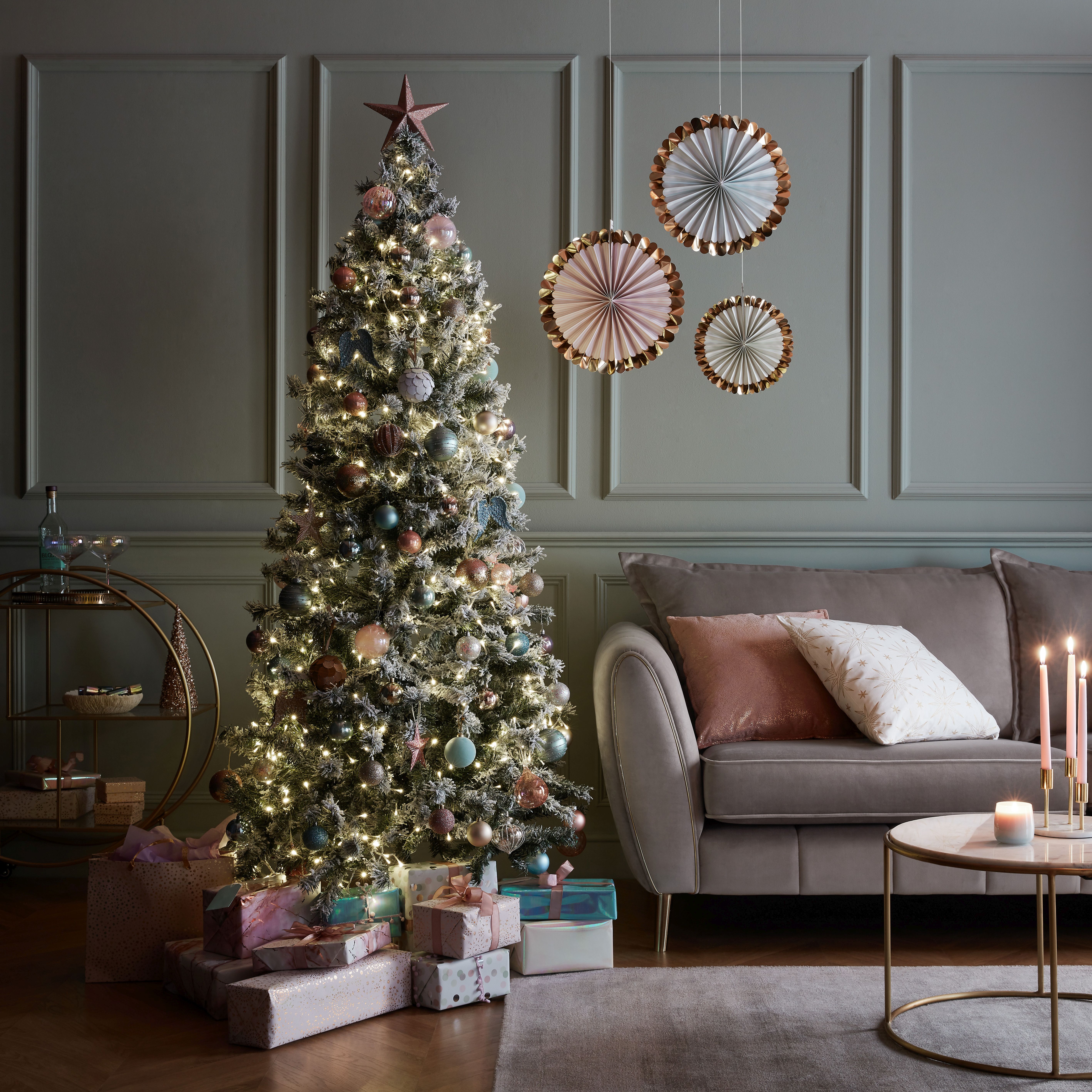 blue wall panelling behind contemporary Christmas tree