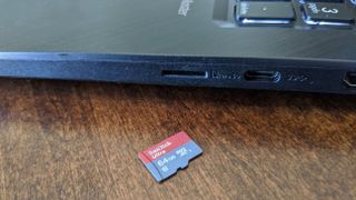 Smaller microSD card next to laptop.