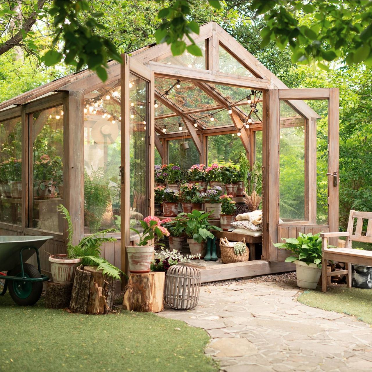 A beautiful wooden greenhouse with open doors