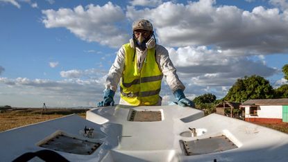 A member of the Food and Agriculture Organization of the United Nations (FAO) prepares insecticide for use 