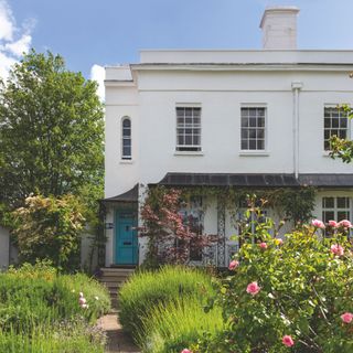 Luscious garden with a white character property in the background