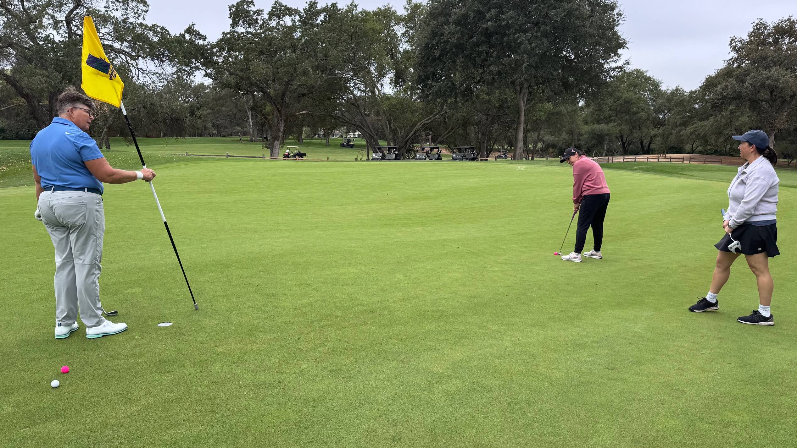 Female golfers on a putting green
