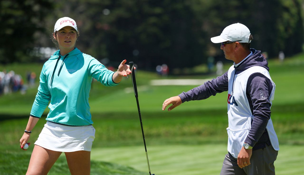 Aine Donegan hands her club back to her caddie