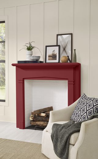 A living room fireplace painted in a dark red crimson color